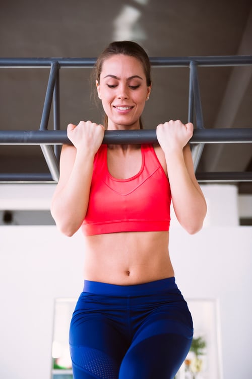 Young Woman Doing Pull-Ups